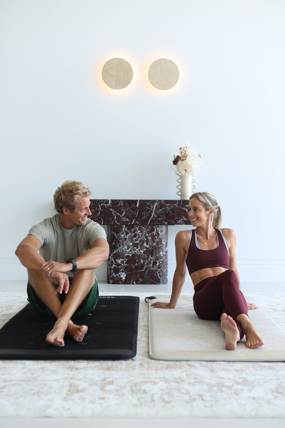 Ben and Tory Giles on the LUM8 Infrared PEMF Crystal Mats in black and beige