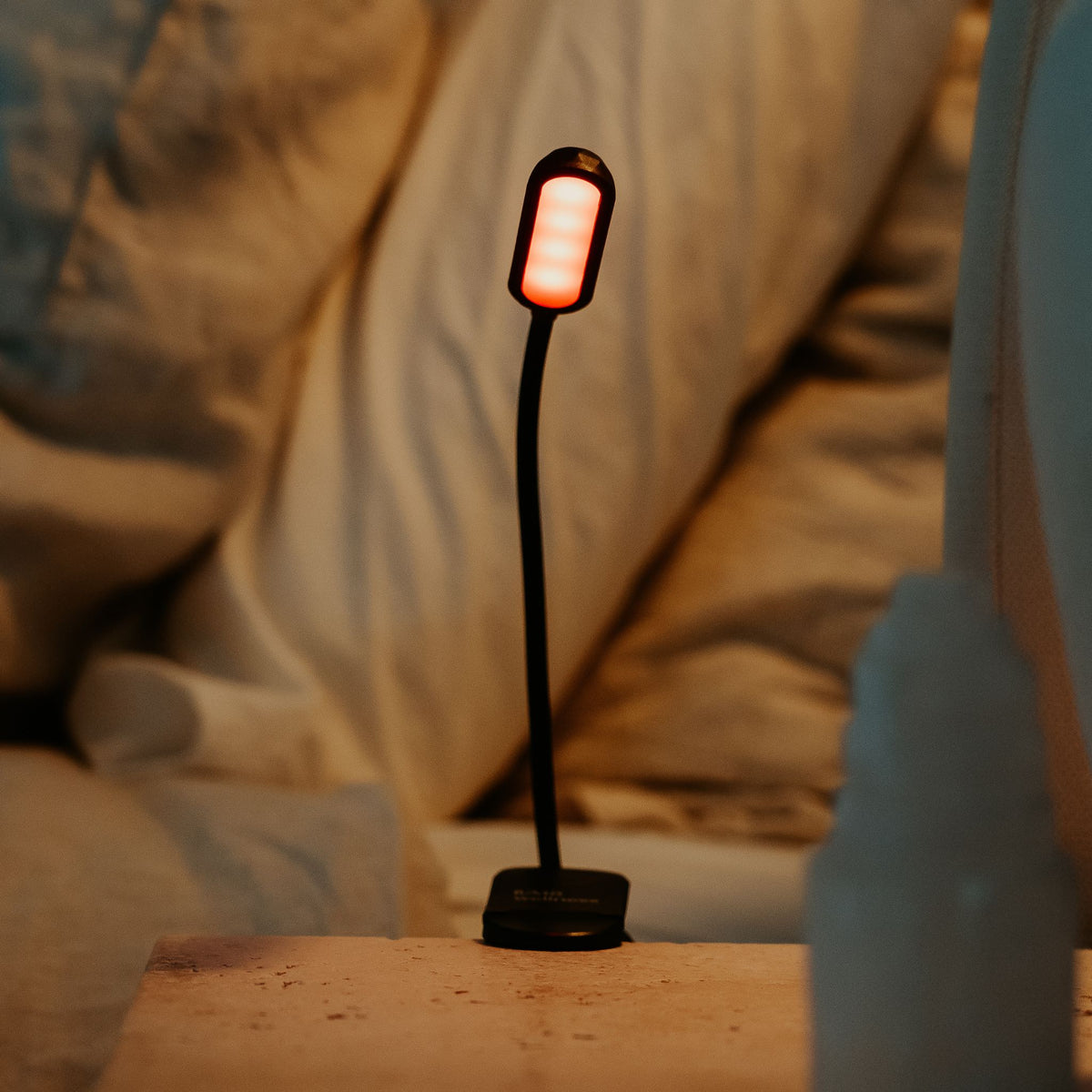 LUM8 Wind Down Reading Light glowing amber on bedside table — evening wind down lighting