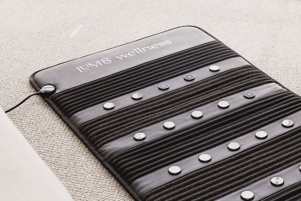 LUM8 PEMF Crystal Mat in use — premium infrared mat with gemstone surface