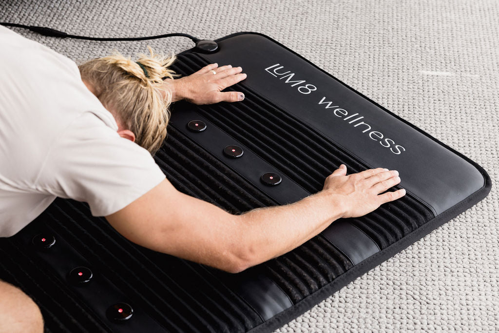 Ben Giles using the LUM8 PEMF Crystal Mat — co-founder and LUM8 wellness technology